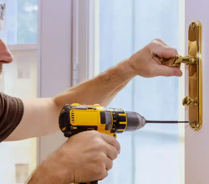 Emergency Locksmith Rutherglen Fixing an UPVC patio door with a cordless drill