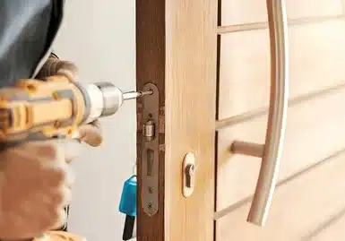 Burglary Repair Fixing the door lock using an electric drill